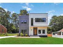 Modern two-story home with gray and white siding, black trim windows, and lush green lawn at 1554 Columbia Cir, Decatur, GA 30032