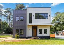 Striking two-story home with a modern design, featuring mixed siding and large windows at 1554 Columbia Cir, Decatur, GA 30032
