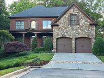 Charming brick and stone home with manicured landscaping and a two-car garage at 1984 Mendenhall Cir, Atlanta, GA 30341