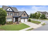 Charming brick home boasts a manicured lawn, two-car garage, and inviting curb appeal at 4010 Cameron Ct, Cumming, GA 30040