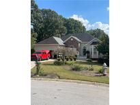 Charming single-story home with stone accents, a manicured lawn, and an attached two car garage in a suburban neighborhood at 5 Glenn Eagles Vw, Hiram, GA 30141