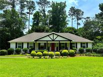 Charming ranch-style home with a manicured lawn, mature trees, and inviting curb appeal at 3548 Liberty Ln, Marietta, GA 30062