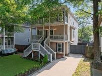 Charming two-story home featuring double porches, a landscaped yard, and a private driveway at 944 Herndon Nw St, Atlanta, GA 30318