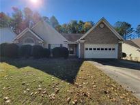 Charming single-story home features a brick facade, two-car garage, and a well-manicured lawn at 983 Noble Oak Ct, Lawrenceville, GA 30046