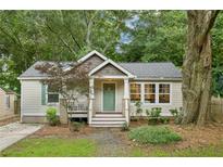 Charming bungalow with a welcoming front porch and mature trees enhancing curb appeal at 1735 Jobeth Se Ave, Atlanta, GA 30316