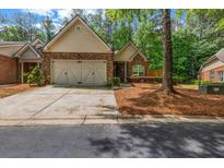 Charming brick home featuring a well-manicured lawn and a two-car garage at 3221 Abbott Dr # 5, Powder Springs, GA 30127