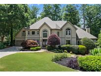 Stunning two-story home boasts professionally landscaped yard and a circular driveway at 5602 Asheforde Ln, Marietta, GA 30068