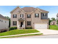 Beautiful two-story brick home featuring a manicured lawn and attached two car garage at 3692 Wartrace Dr, South Fulton, GA 30331