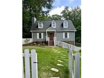Charming home with a well-maintained lawn, picket fence, and inviting front entrance at 4350 Stockton Way, Marietta, GA 30066