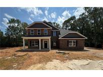 A new two-story brick home with a covered porch and a yard ready for landscaping at 5361 Tuscany Dr, Douglasville, GA 30135