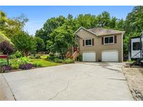 Charming two-story home with two-car garage, landscaped front yard, and inviting entryway at 115 Bennett Farms Dr, Acworth, GA 30102