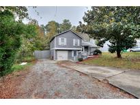 Charming two-story home featuring a gray exterior and a well-maintained front yard at 2573 Mistletoe Ln, Snellville, GA 30039