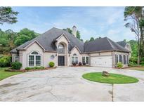 Charming single-Gathering home featuring circular drive, well-manicured lawn and two-car garage at 6065 Standard View Dr, Duluth, GA 30097