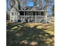 Charming gray home featuring a covered porch and a well-manicured lawn at 1457 Richland Sw Rd, Atlanta, GA 30310
