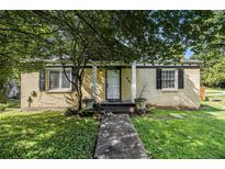 Charming single-story home with painted brick, black shutters, manicured lawn and walkway at 961 Lindbergh Ne Dr, Atlanta, GA 30324