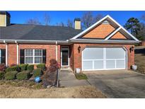 Charming brick home with manicured lawn, two-car garage, and ADT security system at 2500 Rosehill Cir, Lithia Springs, GA 30122