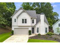 Charming two-story home with landscaped yard, attached garage, and neutral color palette at 3040 Ivey Oaks Ln, Roswell, GA 30076