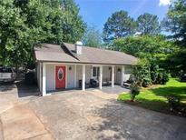 Charming single-story home with a well-maintained yard and inviting front porch at 3356 Hollow Ct, Lawrenceville, GA 30044
