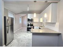 Modern kitchen features stainless steel appliances, granite countertops and stylish tile floors at 3254 Howell Cir, Duluth, GA 30096