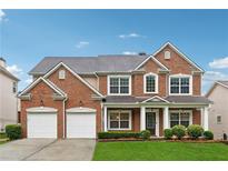 Beautiful two-story brick home with attached two-car garage and manicured lawn at 3569 Tupelo Trl, Auburn, GA 30011