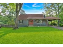 Charming single-story home featuring a well-maintained lawn, portico, and inviting double door entrance at 1731 Maryland Sw Ave, Marietta, GA 30008