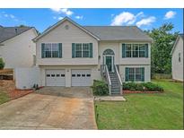 Charming two-story home with a two-car garage and well-maintained front yard at 3383 Spirit Nw Dr, Kennesaw, GA 30144
