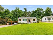 Charming single-story home with a well-manicured front yard, carport, and inviting curb appeal at 1981 Shalimar Ne Dr, Atlanta, GA 30345