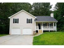 Charming two-story home featuring a front porch, two-car garage, and traditional architectural details at 52 Tide Water Way, Rockmart, GA 30153