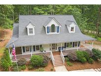 Charming home featuring a welcoming front porch and traditional architectural details nestled among trees at 83 Shipp Cir, Hiram, GA 30141