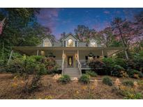 Charming home with a welcoming front porch, lush landscaping, and a serene setting at 83 Shipp Cir, Hiram, GA 30141