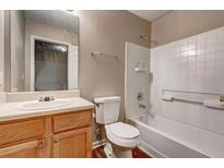 Traditional bathroom features a tub with tile surround, vanity and toilet at 2289 Strathmoor Manor Dr, Lithonia, GA 30058