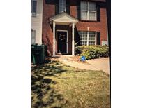 Charming red brick home with a welcoming entryway, decorative door wreath, and well-maintained lawn at 2289 Strathmoor Manor Dr, Lithonia, GA 30058