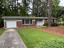 Charming brick home with well-maintained lawn and mature trees at 1177 Baker Ln, Marietta, GA 30062