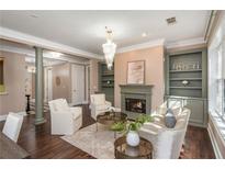 Elegant living room with fireplace, built-in bookshelves, and refined decor for a cozy yet luxurious ambiance at 3280 Stillhouse Se Ln # 108, Atlanta, GA 30339