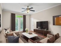 Bright living room features neutral decor, a ceiling fan, balcony access and comfortable seating at 4248 River Green Nw Dr # 310, Atlanta, GA 30327