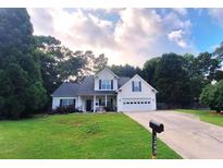 Charming two-story home featuring a well-manicured lawn, an attached two-car garage, and classic curb appeal at 1245 Cedar Oak Ln, Lawrenceville, GA 30043