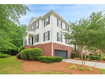 Charming two-story home features a brick foundation, white siding, and a well-manicured lawn at 4228 Laurel Creek Se Ct # 6, Smyrna, GA 30080
