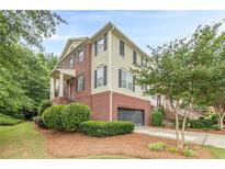 Charming brick and siding townhome with a two-car garage and manicured landscaping at 4228 Laurel Creek Se Ct # 6, Smyrna, GA 30080