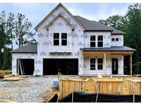 Two-story home construction featuring large windows and an attached two-car garage at 723 Crest Line Trl, Powder Springs, GA 30127