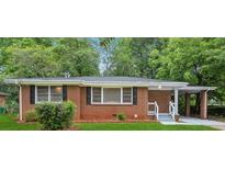 Charming brick ranch home with well-maintained landscaping and a convenient carport at 2858 Valley Ridge Dr, Decatur, GA 30032