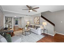Cozy living room features hardwood floors, neutral decor, and a contemporary ceiling fan at 4960 Meadow Ln, Marietta, GA 30068