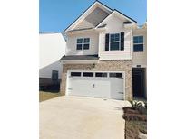Charming two-story home with brick accents and a convenient two-car garage at 1400 Gray Branch Dr, Lawrenceville, GA 30045
