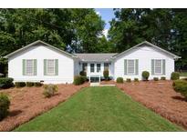 Charming single-story home with a well-manicured front lawn and inviting curb appeal at 402 Princeton Way, Lawrenceville, GA 30044