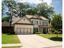 Beautiful two-story home with well-manicured lawn, brick accents, and a two-car garage at 2159 Holland Creek Ln, Buford, GA 30519