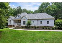 Charming single-story home featuring a well-manicured lawn and traditional architectural details at 1460 Bakers Bridge Rd, Douglasville, GA 30134