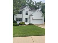 Charming two-story home with a lush green lawn and beautiful, freshly-painted white brick exterior at 5920 Findley Chase Dr, Johns Creek, GA 30097