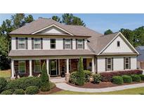 Beautiful two-story home with stone and siding, professional landscaping, and charming front porch at 140 Discovery Lake Dr, Fayetteville, GA 30215