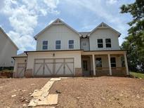 Charming two-story home with a spacious two-car garage and inviting front porch at 344 Riverwood Pass, Dallas, GA 30157