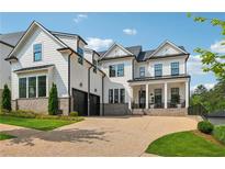 Stunning two-story home with white siding, brick accents, and a two-car garage at 4020 Connolly Ct, Roswell, GA 30075