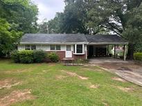Traditional home with a quaint front yard and a convenient carport at 2588 Sandtown Sw Rd, Marietta, GA 30060